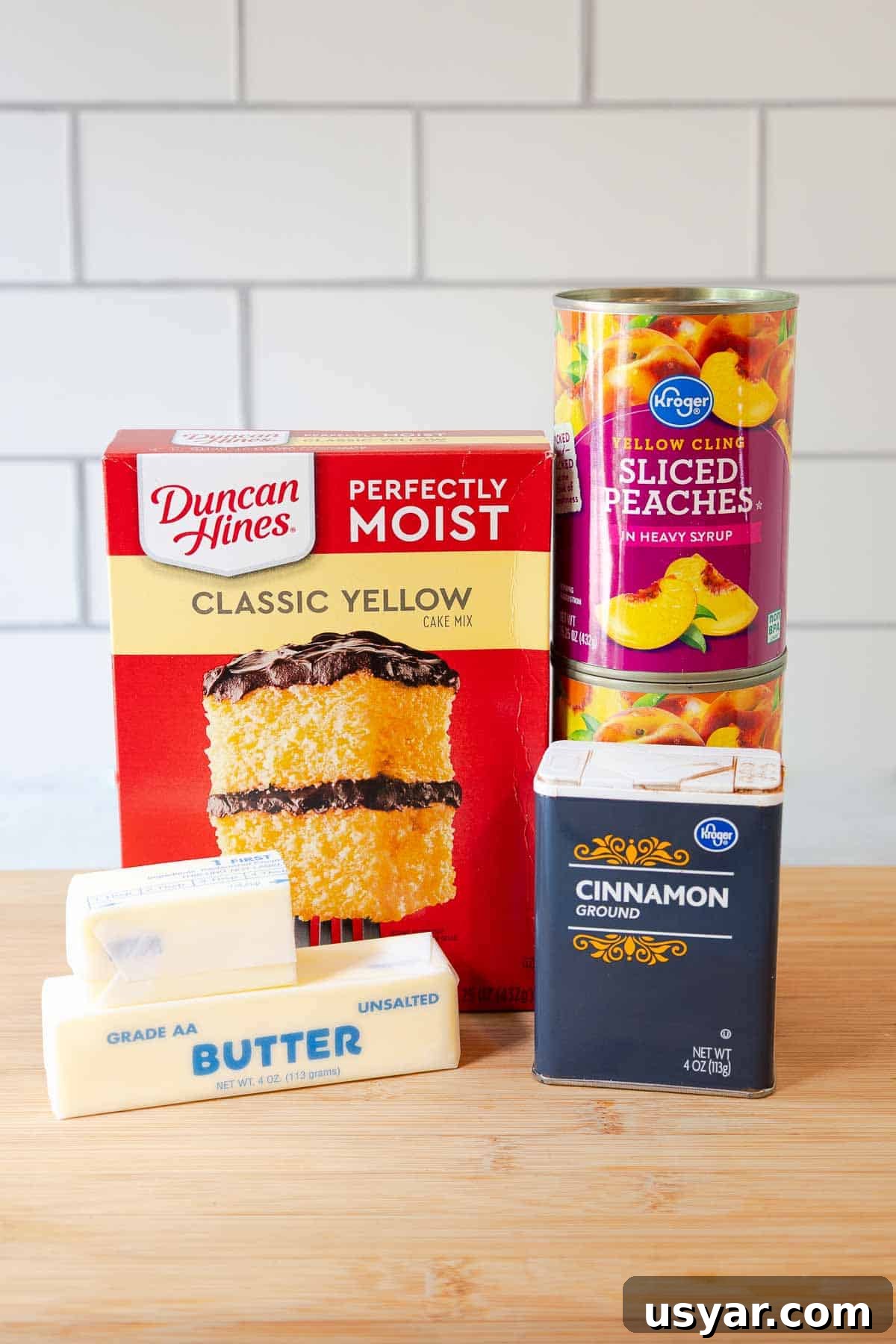 Cake Mix Peach Cobbler with Canned Peaches 3 Box of yellow cake mix, two cans of sliced peaches, ground cinnamon, and two sticks of butter.