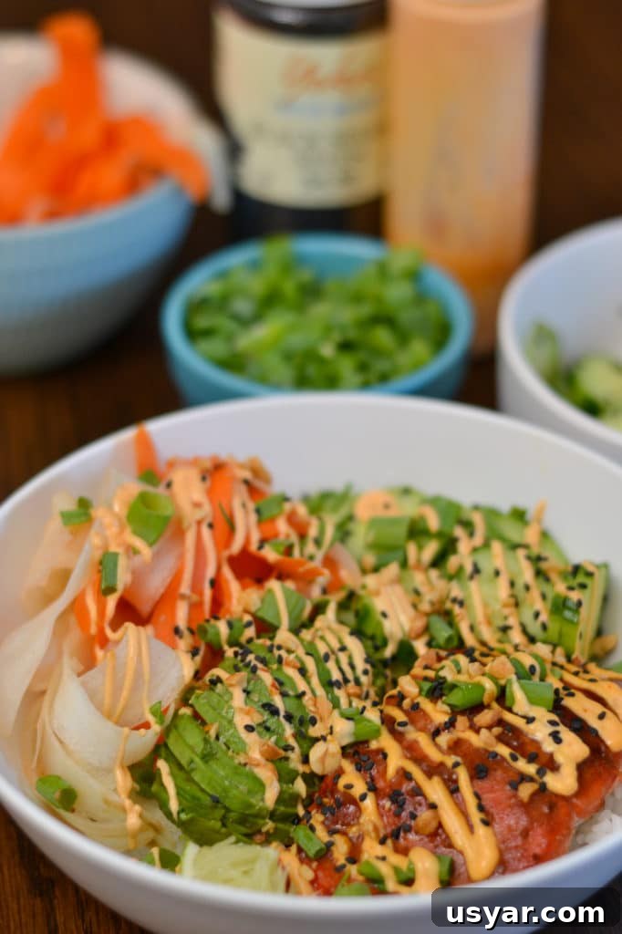 Teriyaki Salmon Rice Bowls with Sesame and Scallions 2 Teriyaki salmon bowl with rice, avocado, cucumbers, carrots and peanuts