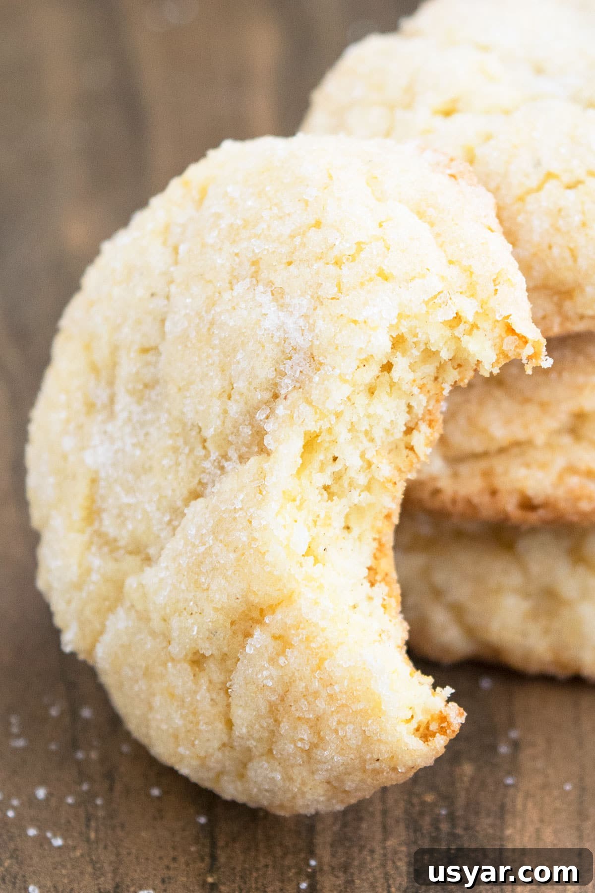 Partially Eaten Cookie on Wood Background.