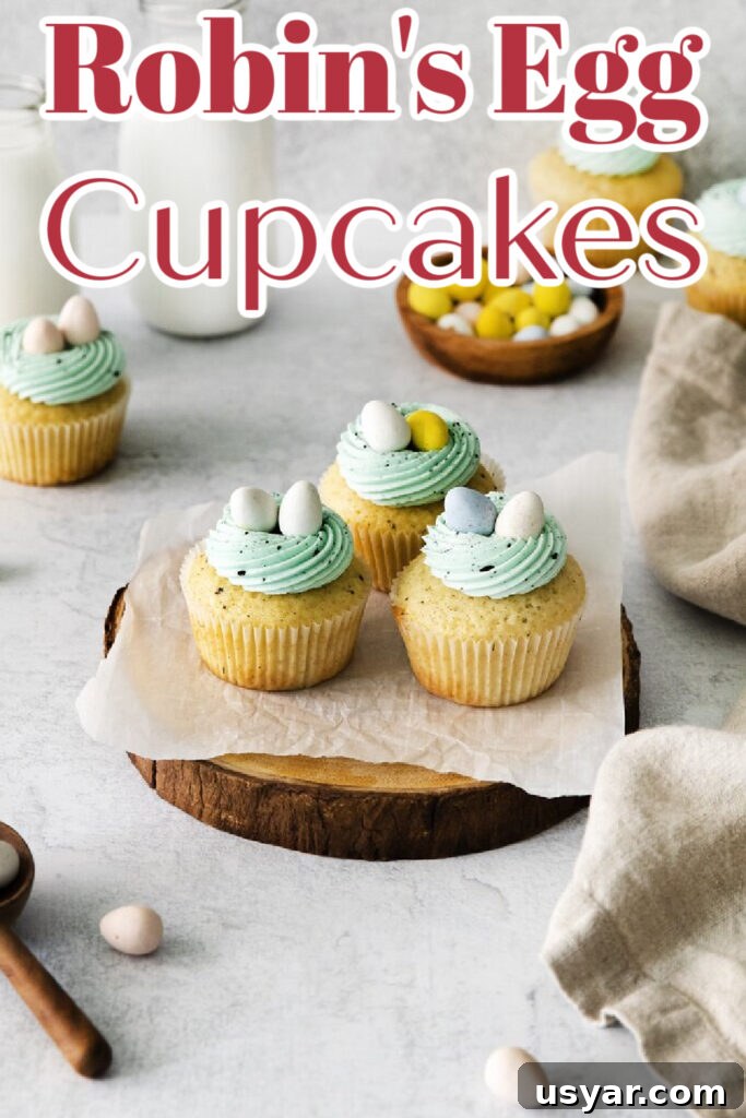 Stack of cupcakes with blue frosting and candy eggs