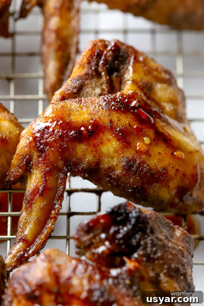 Jerk chicken wings with hot honey on a wire rack. 