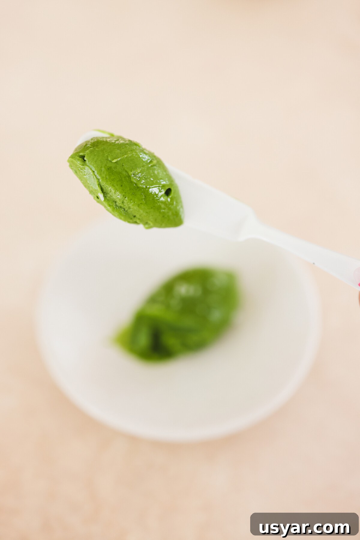 Vegan Matcha Butter Recipe: Sweet and Creamy Spread 8 a knife lifting a scoop of spread off a white plate