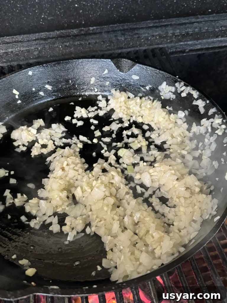 Homemade Chili Cheese Coneys Recipe 5 cooking the onions and garlic in a cast iron
