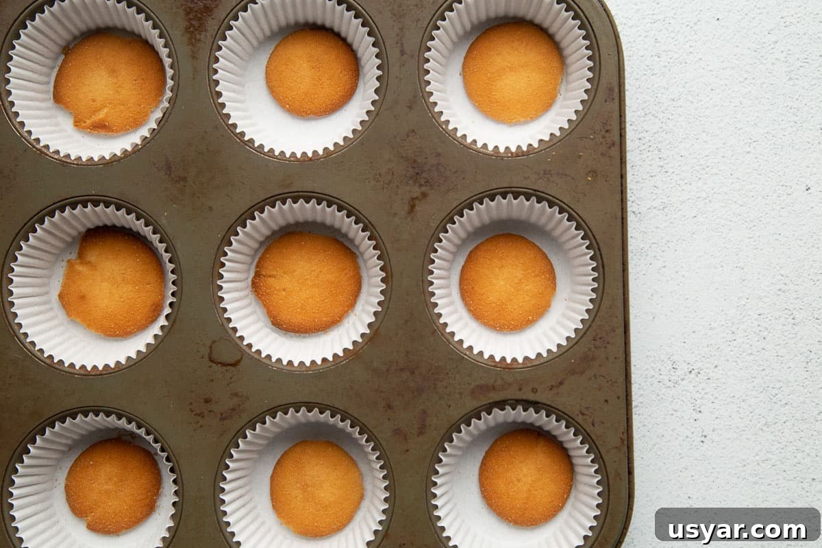 Mini Cherry Cheesecakes with Graham Cracker Crust 4 vanilla wafers in cupcake liners in a 12-cup muffin tin.