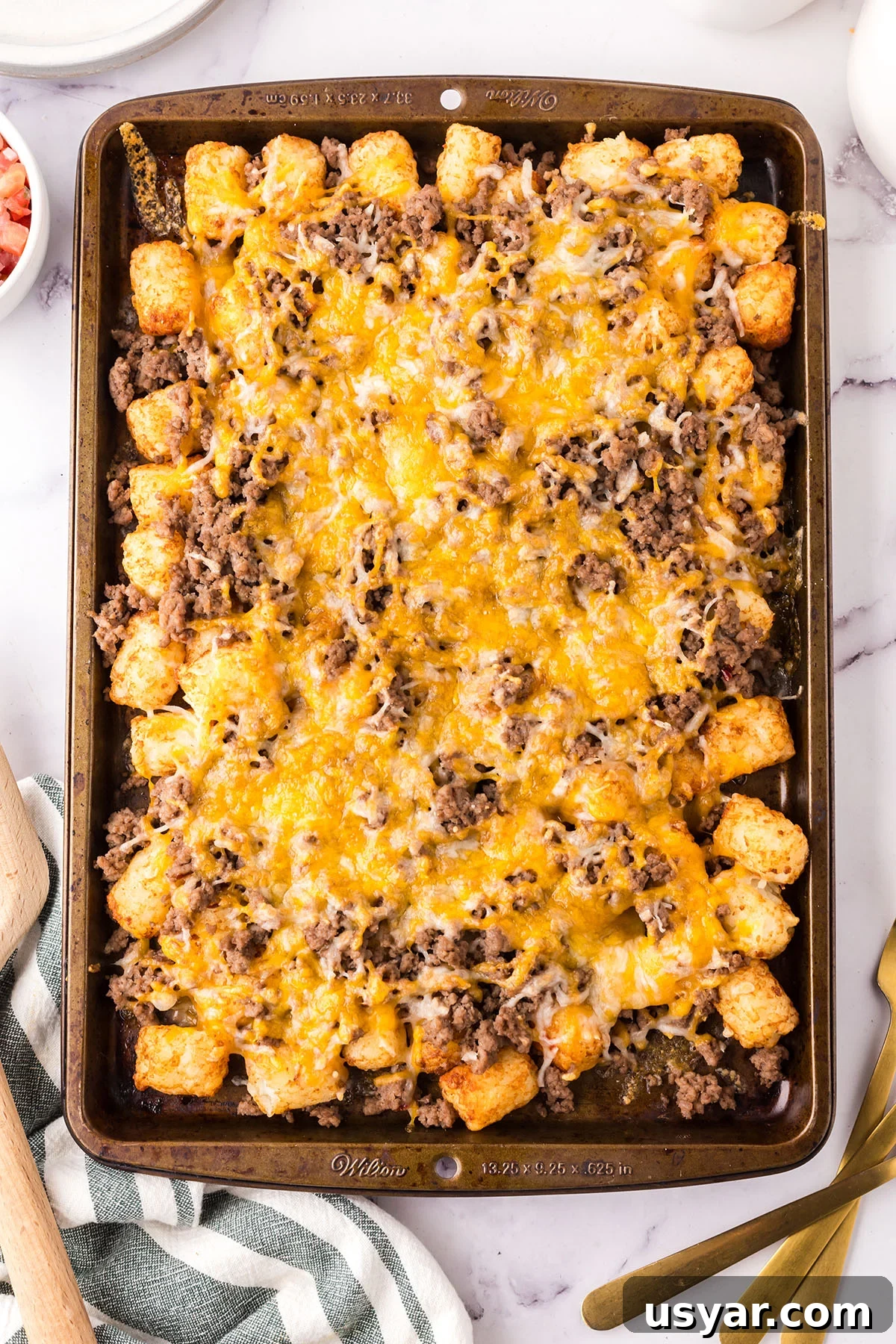 Mexican Totchos: Tater Tot Nachos with Pico and Cheese 7 Baked Mexican Totchos on a baking sheet.