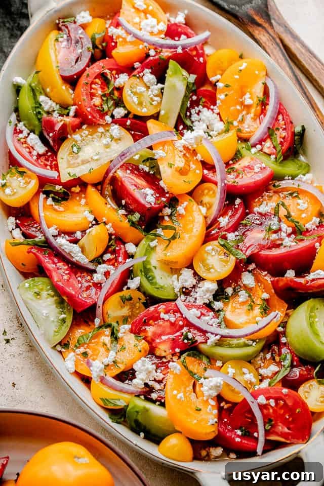 Heirloom Tomato Salad with Basil Vinaigrette 5 wedges of colored tomatoes topped with slices of red onions and crumbled feta cheese