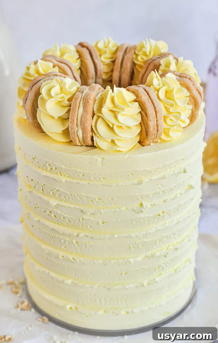 Homemade Pink Lemonade Cake Recipe 2 A yellow cake with yellow frosting swirls on top and a golden cookie between each swirl.