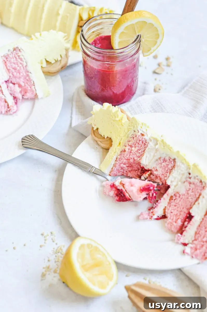 Homemade Pink Lemonade Cake Recipe 5 A slice of pink lemonade cake filled with raspberry curd filling and frosted in a yellow lemon buttercream.
