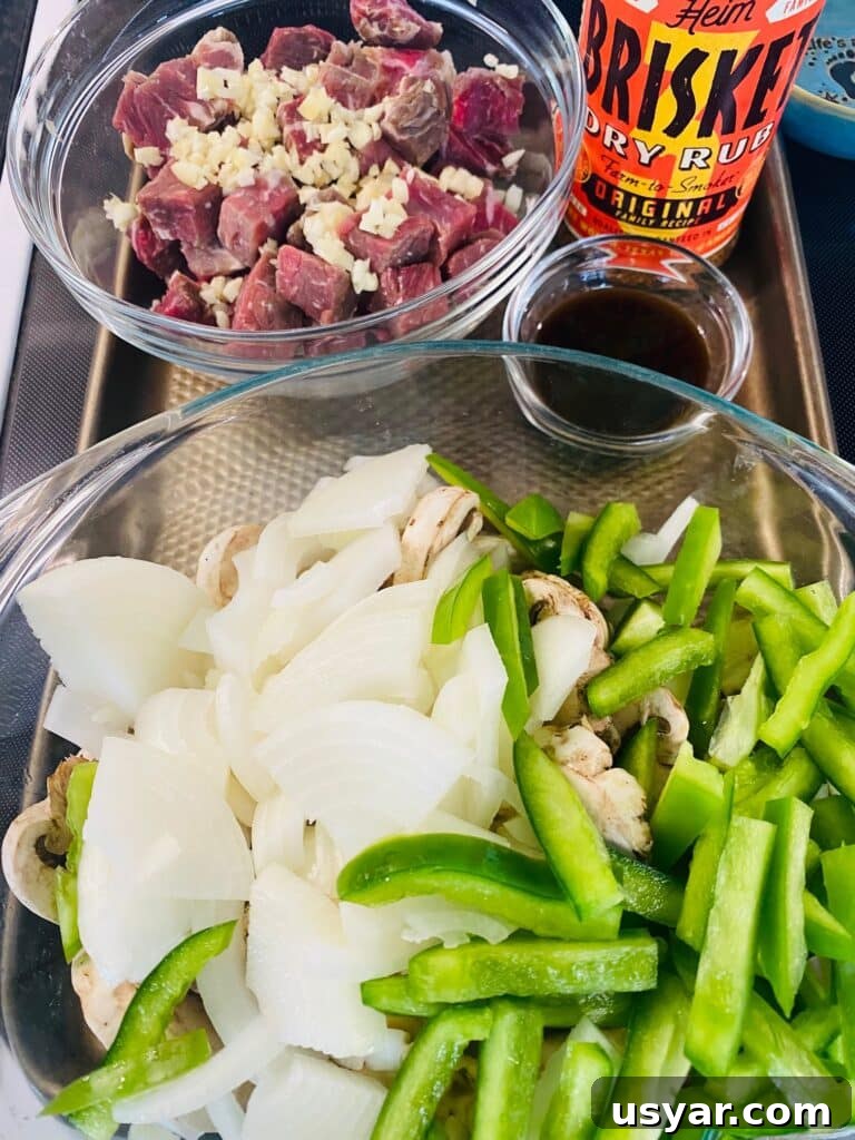 Philly Cheesesteak Burrito Recipe for Blackstone Griddle 3 prepped ingredients on a tray for the burritos