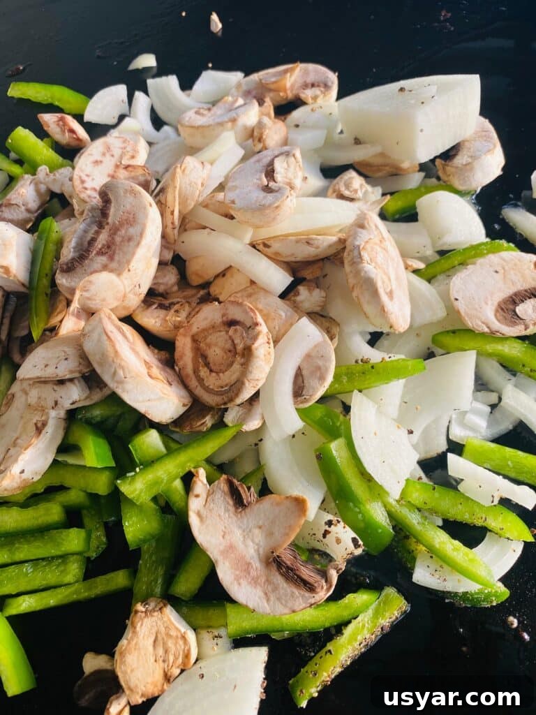 Philly Cheesesteak Burrito Recipe for Blackstone Griddle 5 veggies on the griddle before cooking