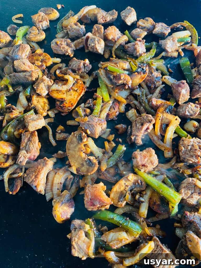 Philly Cheesesteak Burrito Recipe for Blackstone Griddle 7 cooked Philly Cheesesteak filling on the griddle