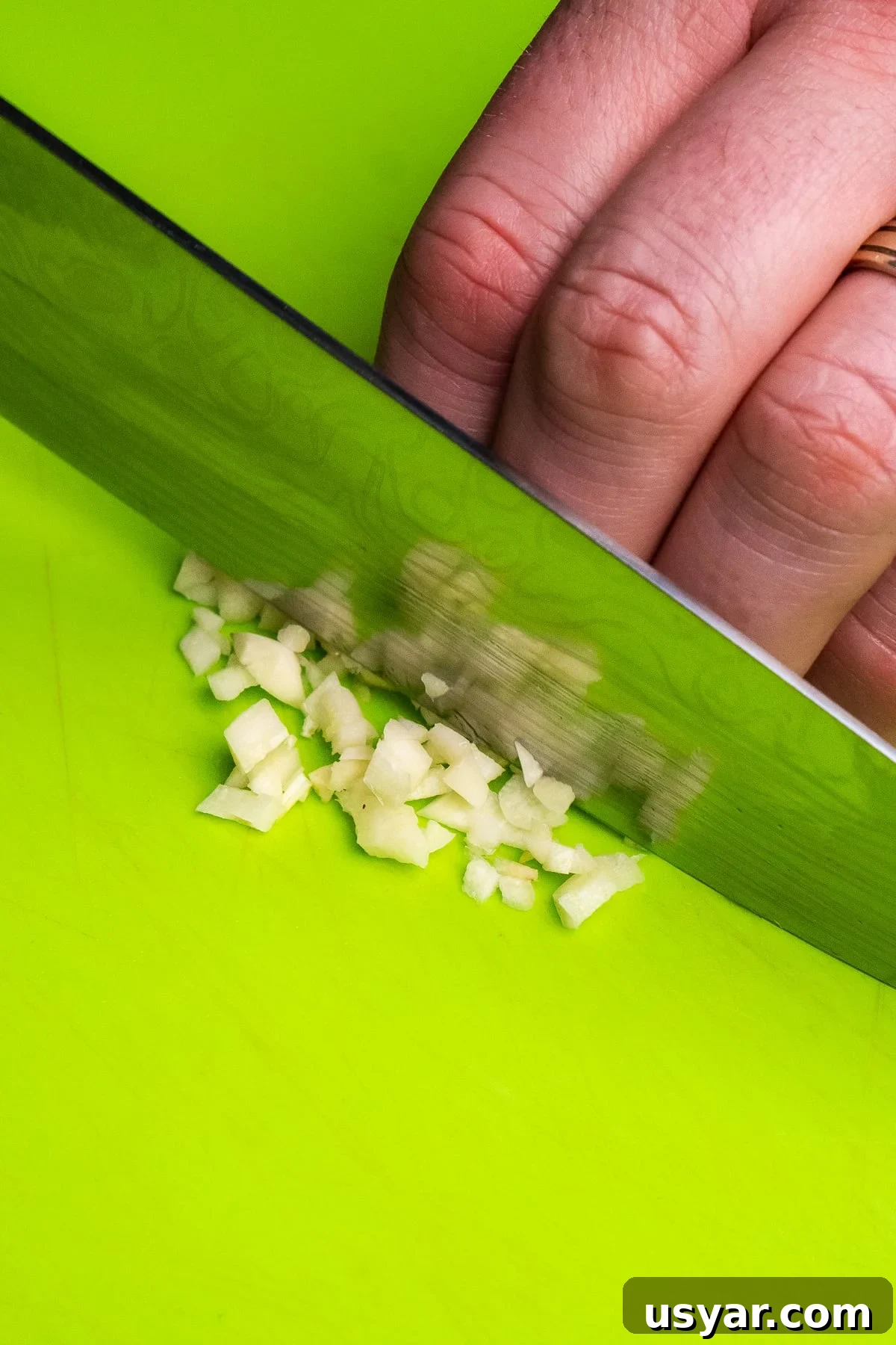 Chopping up a garlic clove with a sharp knife