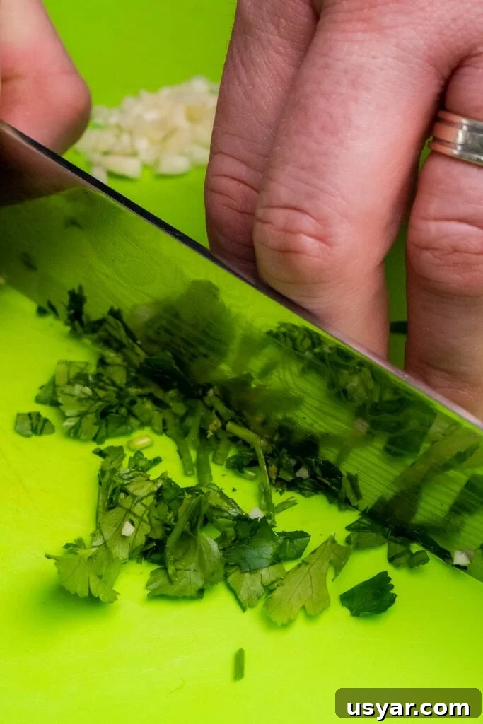Chopping up fresh parsley up with a sharp knife