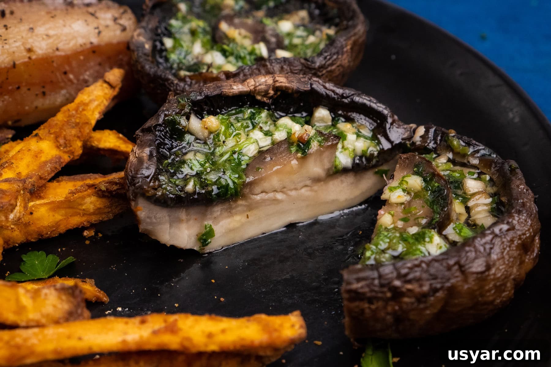 Air Fryer Mushrooms - Garlic Portobello chopped in half served next to sweet potato