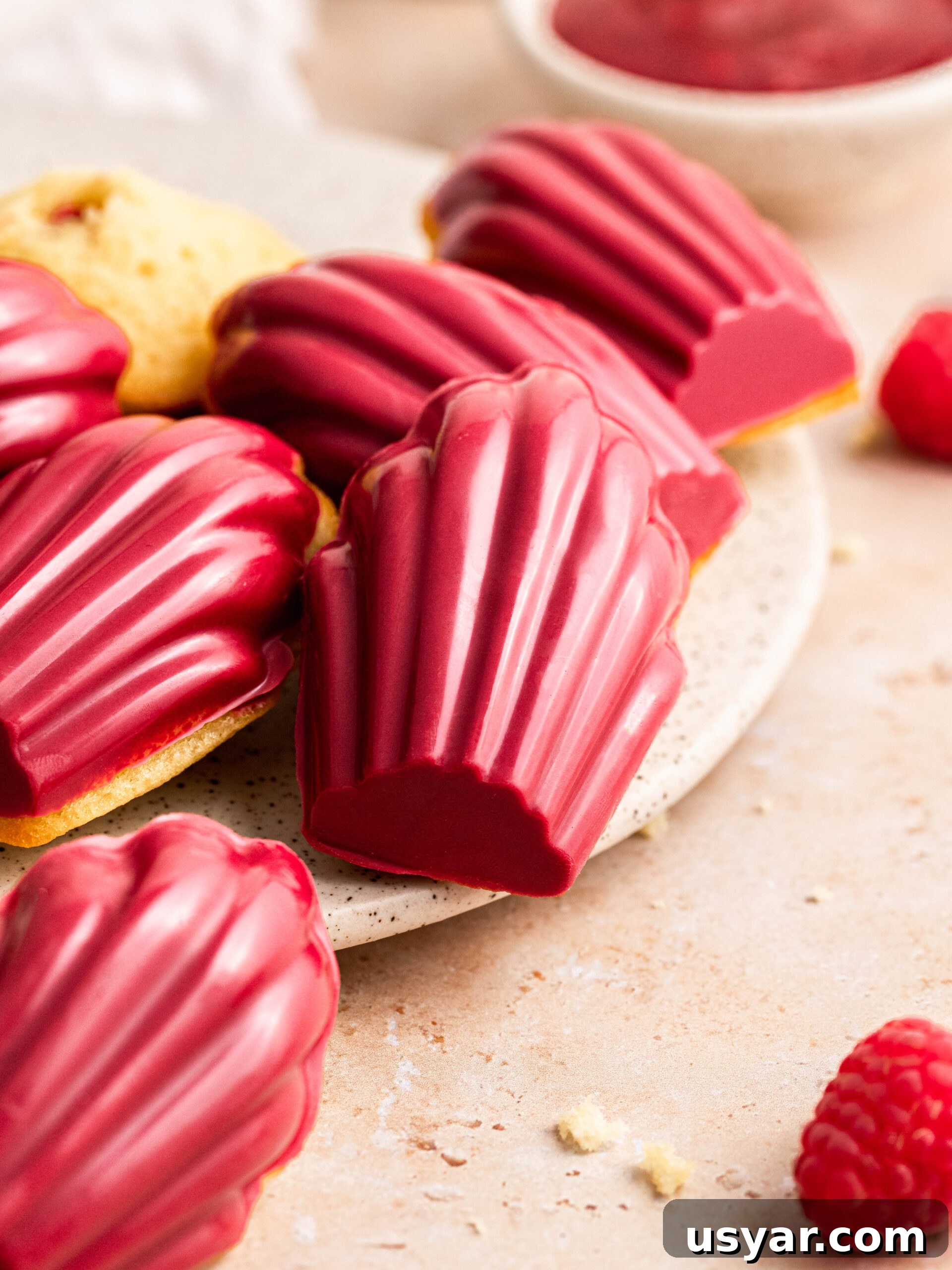 raspberry madeleines dipped in raspberry chocolate.