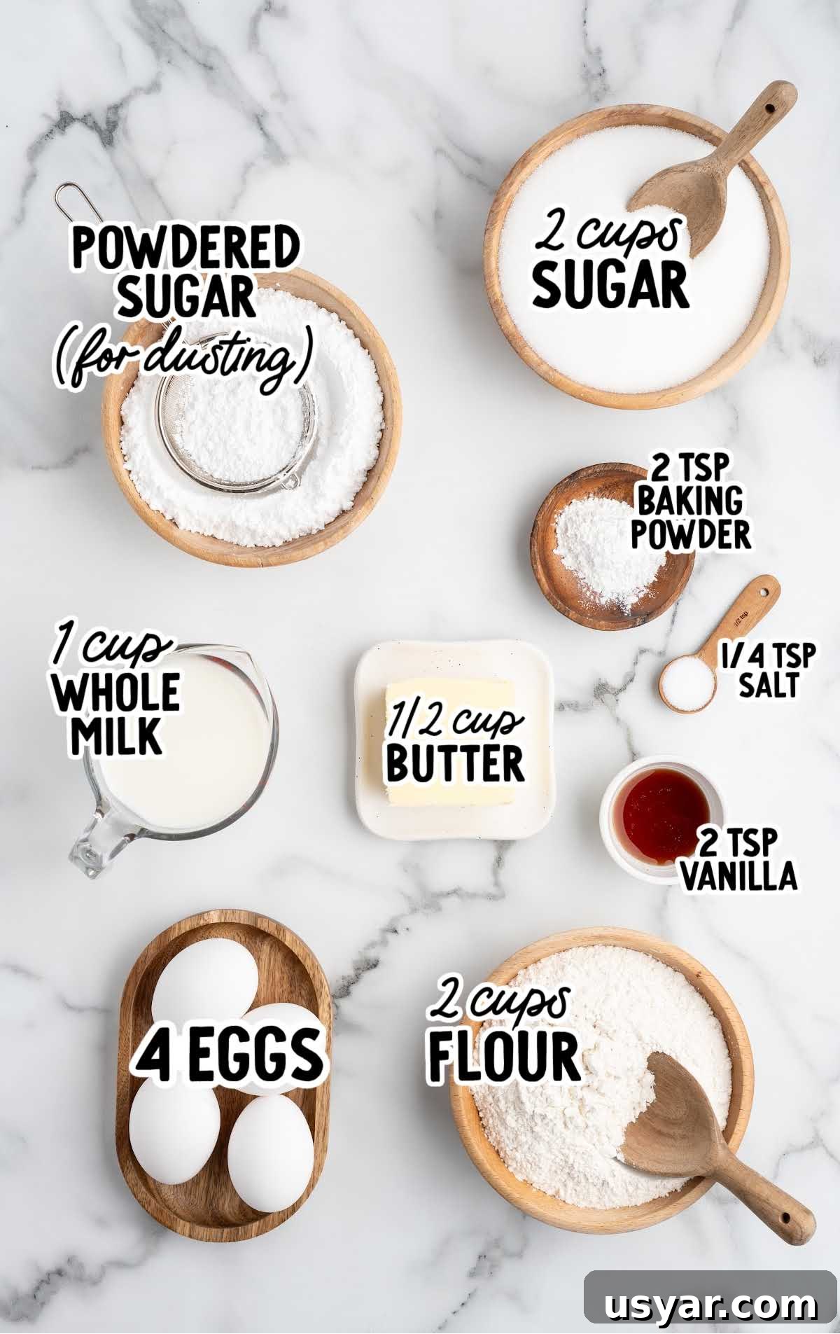 Vintage Hot Milk Cake Recipe 3 Overhead view of hot milk cake ingredients measured out and labeled on a marble surface.