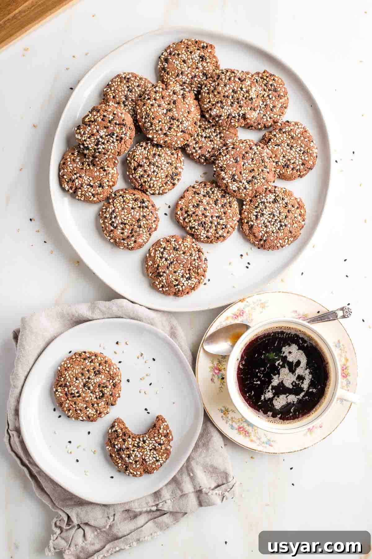 Crispy Sesame Seed Cookies Recipe 2 Plate of cookies topped with sesame seeds, a cup of coffee and a small plate of cookies.