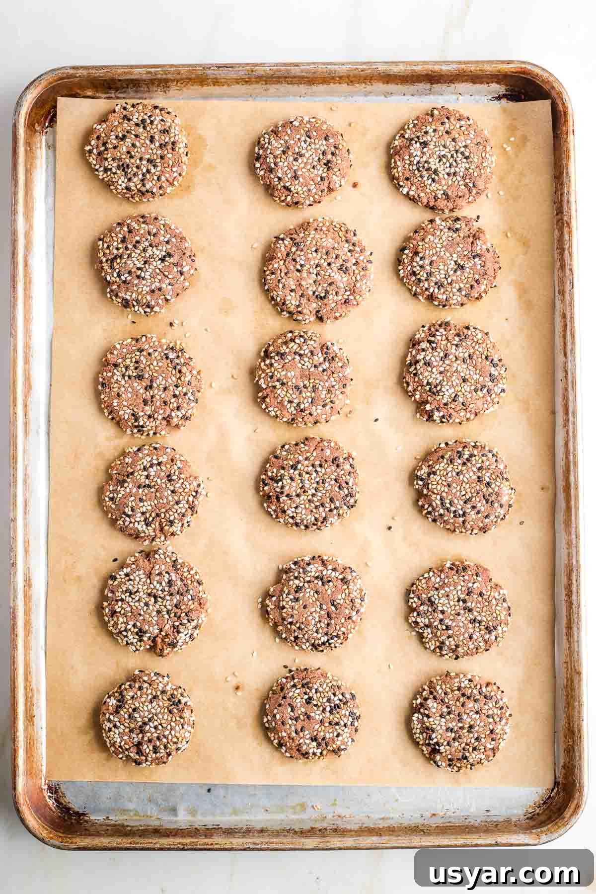 Crispy Sesame Seed Cookies Recipe 11 Baking sheet filled with baked sesame seed cookies.