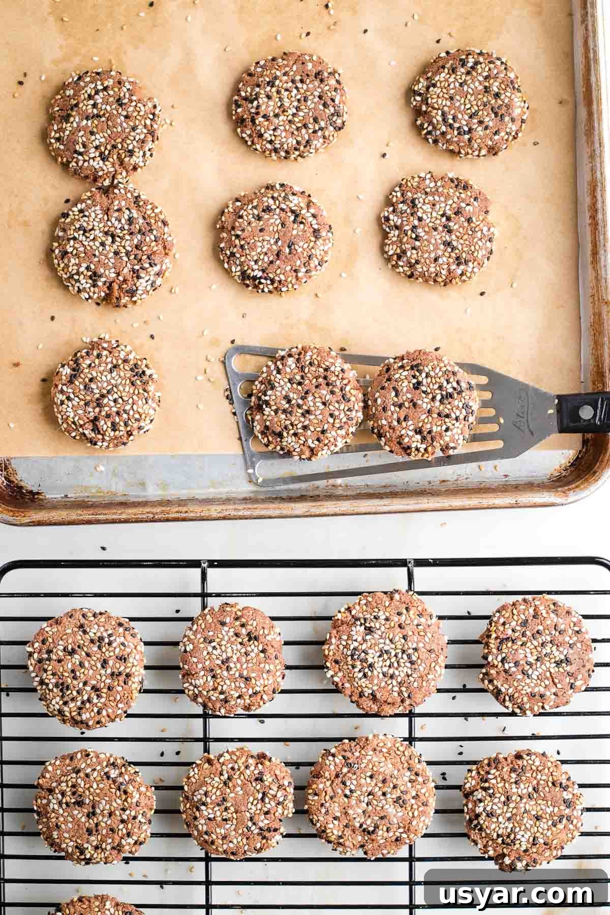 Crispy Sesame Seed Cookies Recipe 12 Spatula transferring sesame seed cookies from parchment lined baking tray to wire rack.