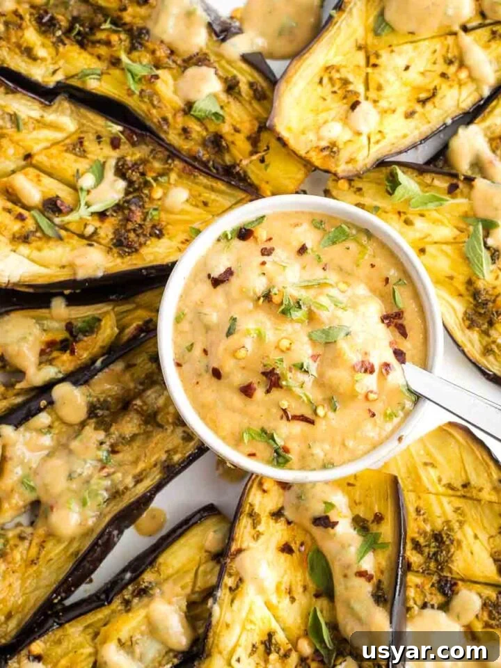 Roasted eggplant with fresh herbs and a tahini sauce.