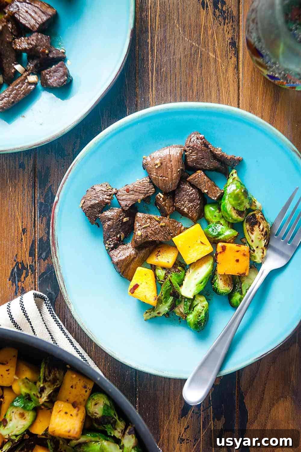 rosemary balsamic marinated steak tips with butternut squash and Brussels sprouts on a plate