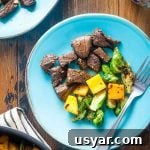 rosemary balsamic marinated steak tips with butternut squash and Brussels sprouts on a plate