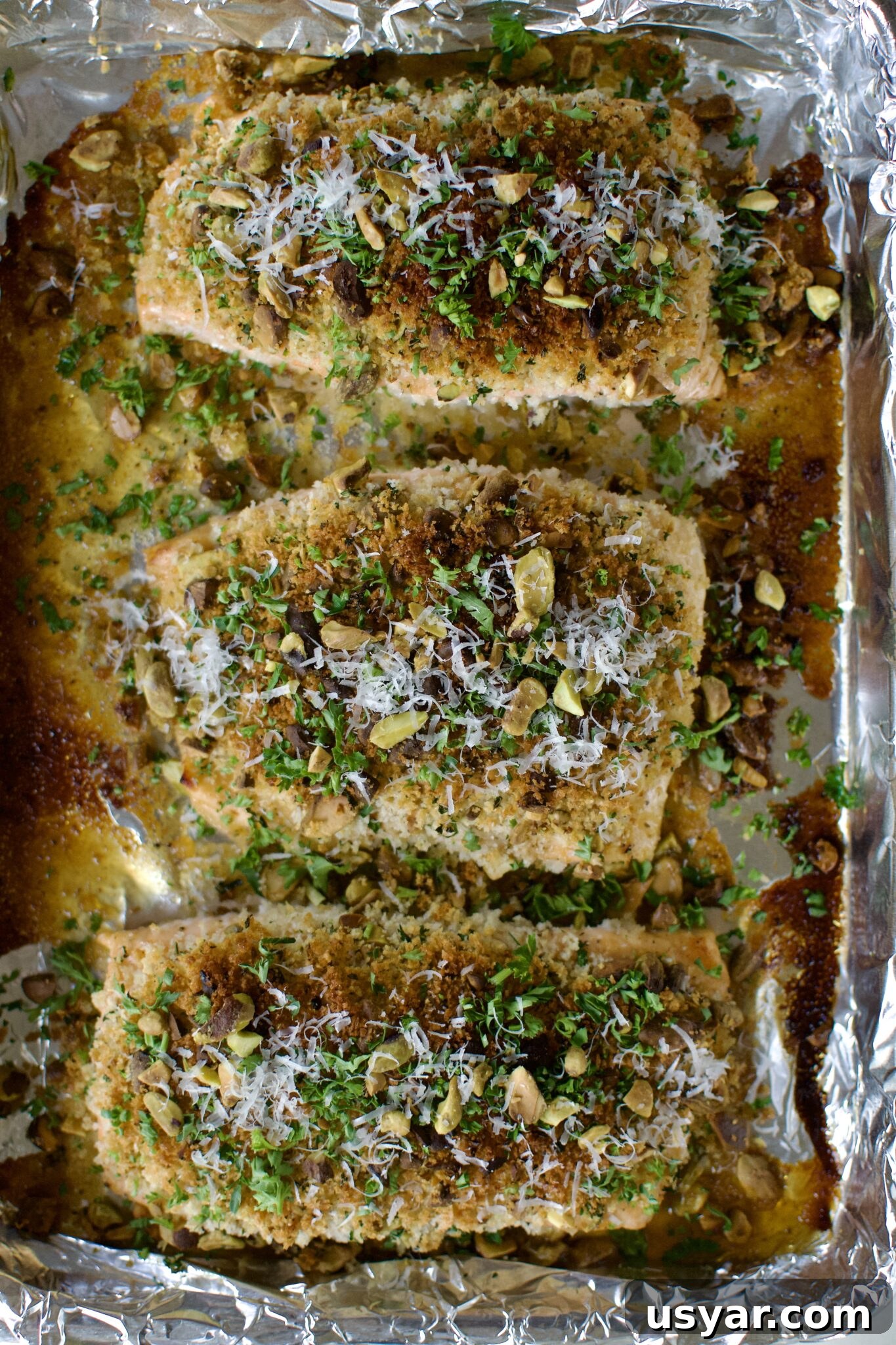 Pistachio Crusted Salmon fresh out of the oven, topped with parsley and parmesan.