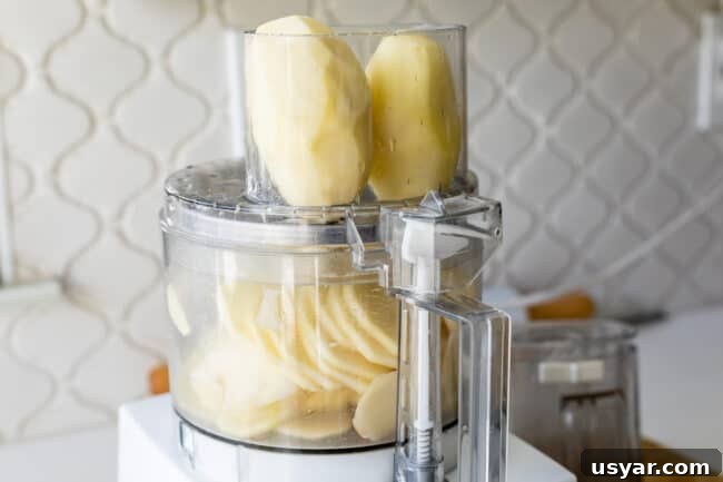 potatoes in a food processor, ready to be sliced