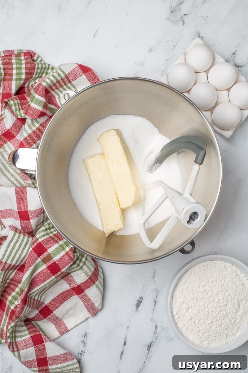 Cinnamon-Apple Pie Bars with Vanilla Glaze 4 Butter and sugar in mixing bowl with paddle attachment from stand mixer.
