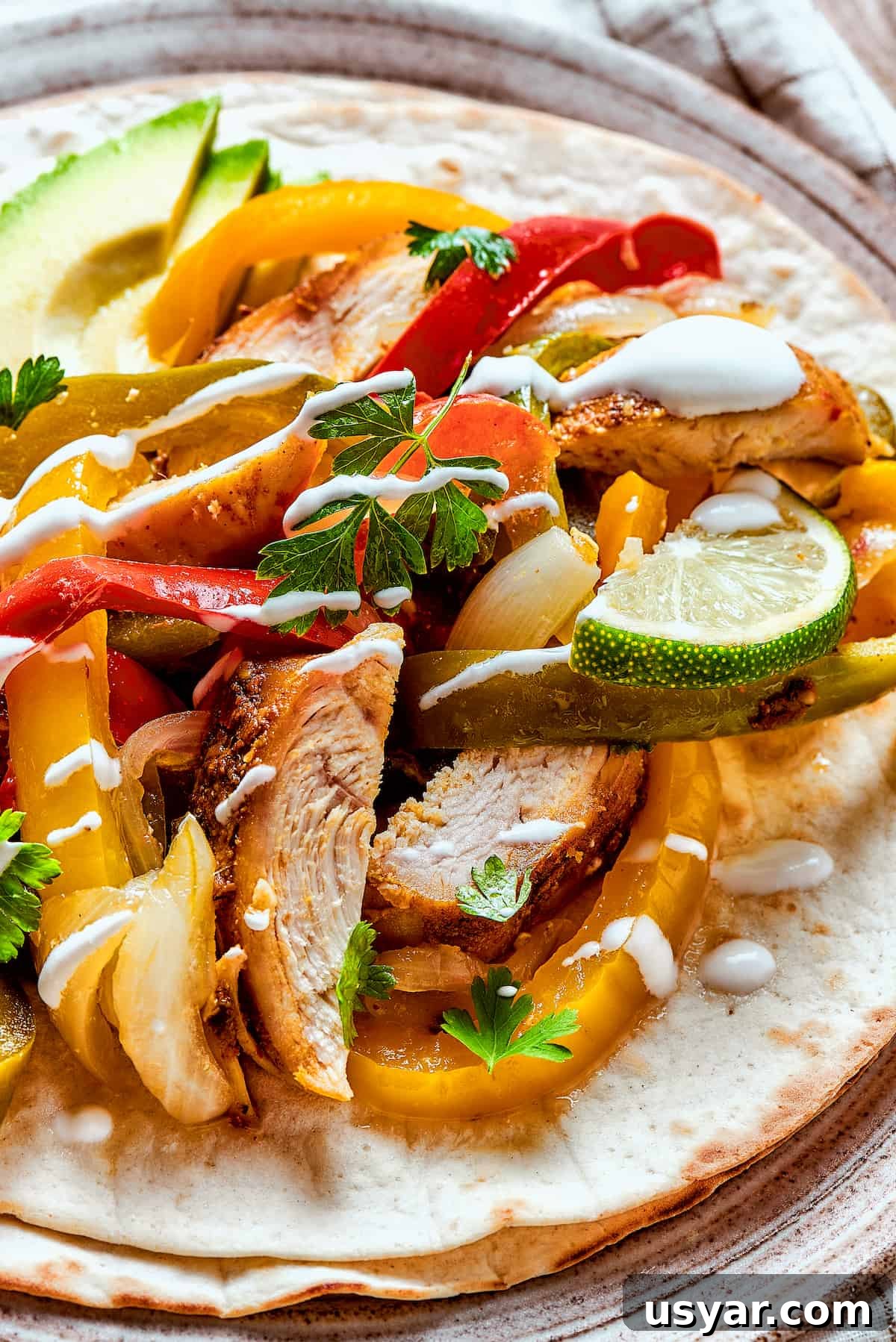 These perfectly-seasoned Crockpot Chicken Fajitas are easy to make, perfect for busy days when you want a home-cooked meal without the hassle! Slow cooker chicken fajitas with sour cream.