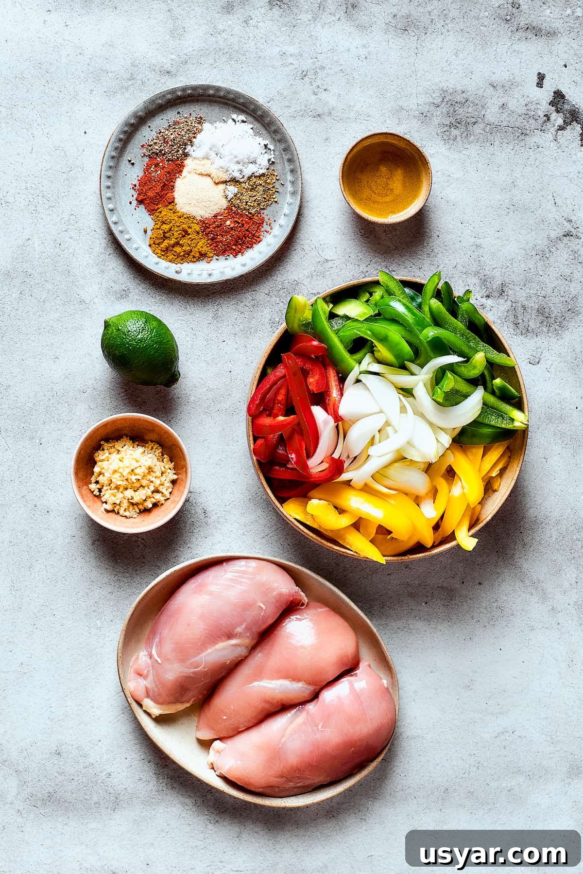 These perfectly-seasoned Crockpot Chicken Fajitas are easy to make, perfect for busy days when you want a home-cooked meal without the hassle! Ingredients for crockpot fajitas arranged on a work surface.