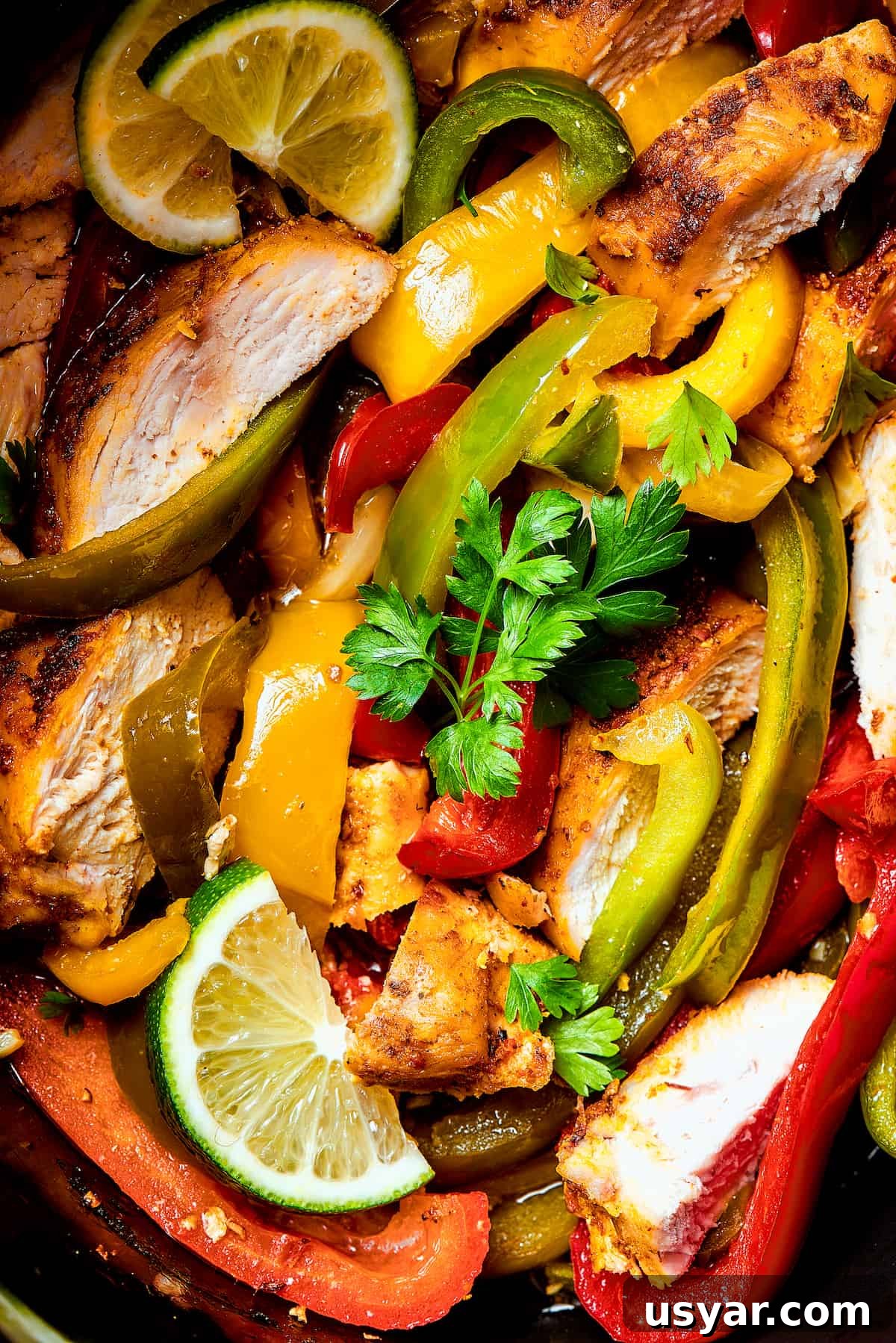 These perfectly-seasoned Crockpot Chicken Fajitas are easy to make, perfect for busy days when you want a home-cooked meal without the hassle! Close-up shot of seasoned chicken and veggies in a slow cooker.