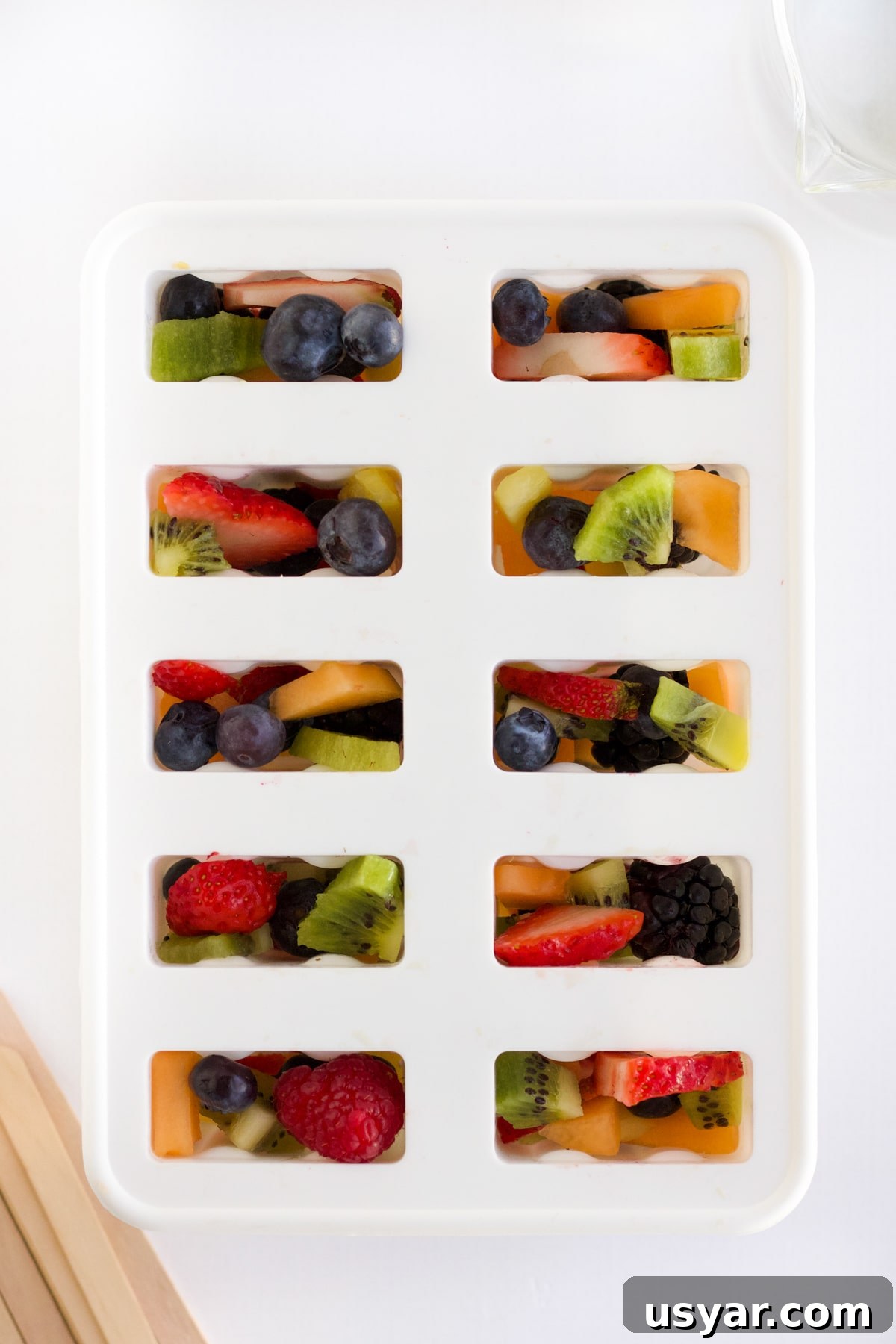 overhead shot of fruit popsicles ready to go in the freezer
