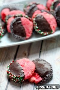 Cherry Shortbread Cookies with White Chocolate 2 White Chocolate Cherry Shortbread Cookies made with white chocolate, maraschino cherries, and dipped chocolate for a festive Christmas cookie recipe.