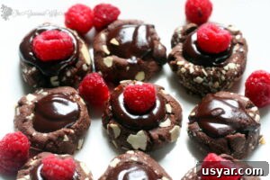 Cherry Shortbread Cookies with White Chocolate 7 Raspberry Ganache Thumbprints with chocolate thumbprint cookies, chocolate raspberry ganache, and fresh raspberries.