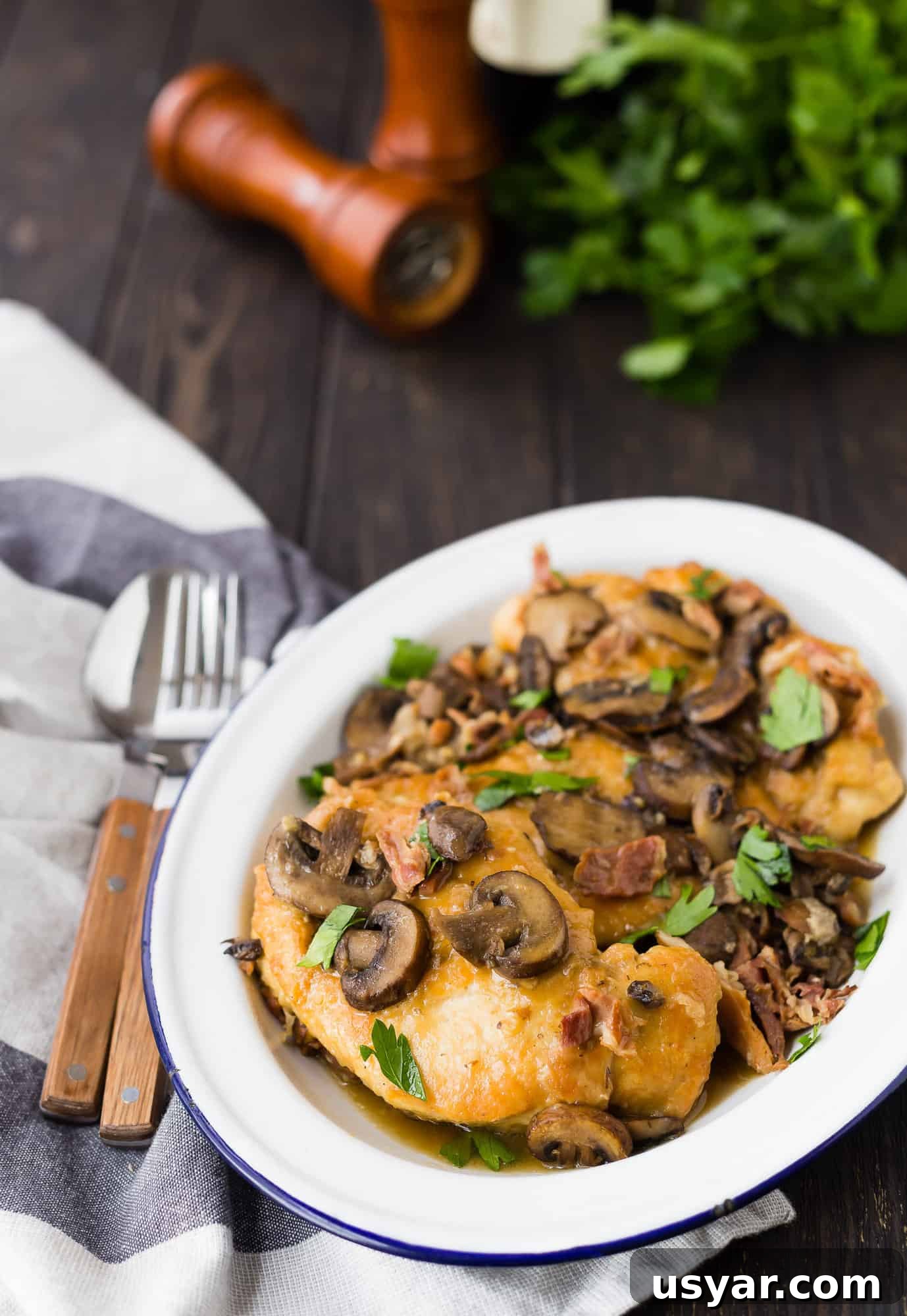 Instant Pot Chicken Marsala in 30 Minutes 2 Chicken marsala on plate garnished with parsley.