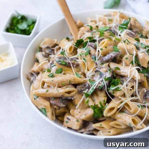 Instant Pot Chicken Marsala in 30 Minutes 9 Chicken marsala pasta with a wooden spoon.