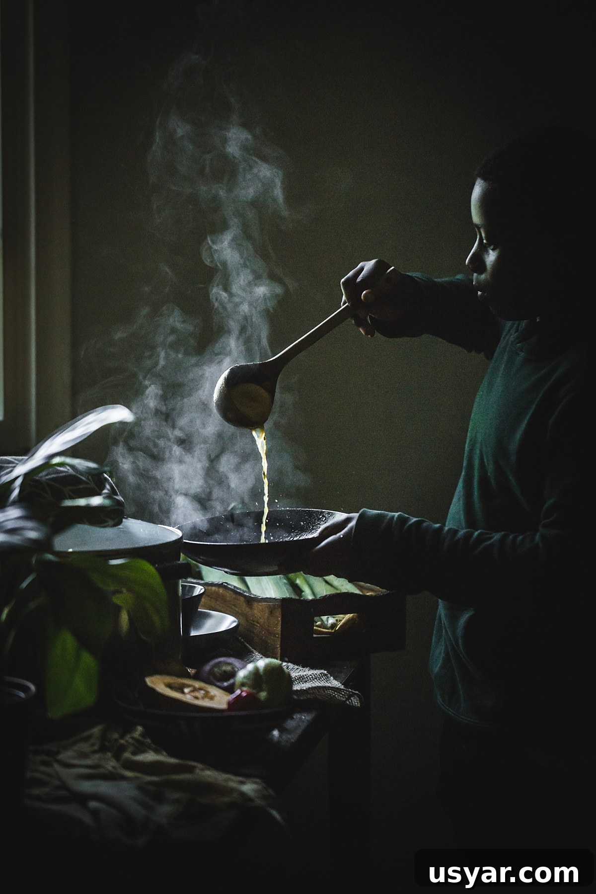 Authentic Jamaican Chicken Soup with Dumplings 8 backlit shot of boy pouring Jamaican chicken soup into bowl