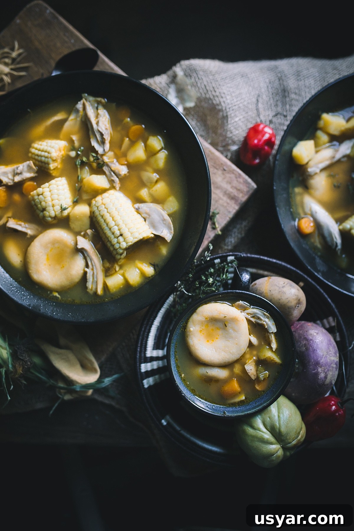 Authentic Jamaican Chicken Soup with Dumplings 10 Overhead shot of three different sized bowls of Jamaican chicken soup with dumpling