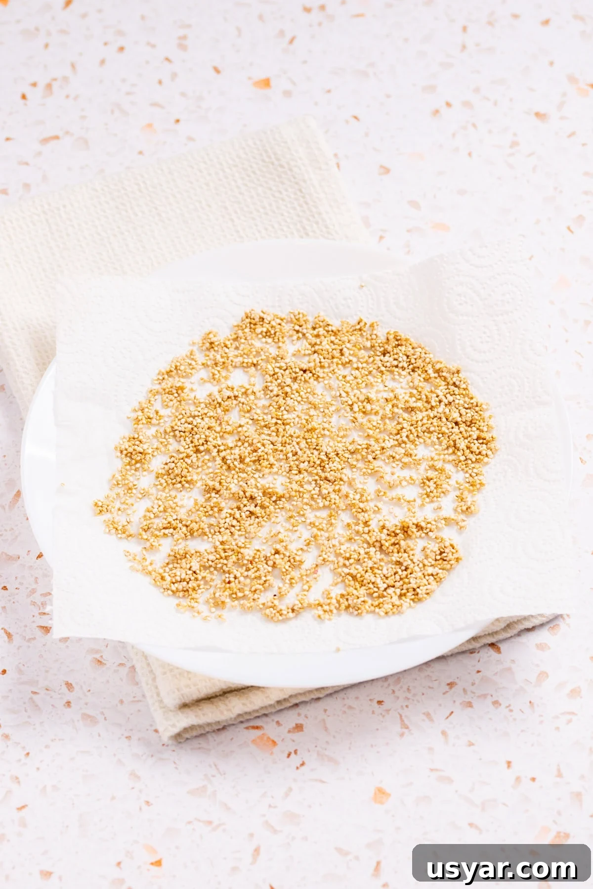 An image of uncooked quinoa on a kitchen towel.