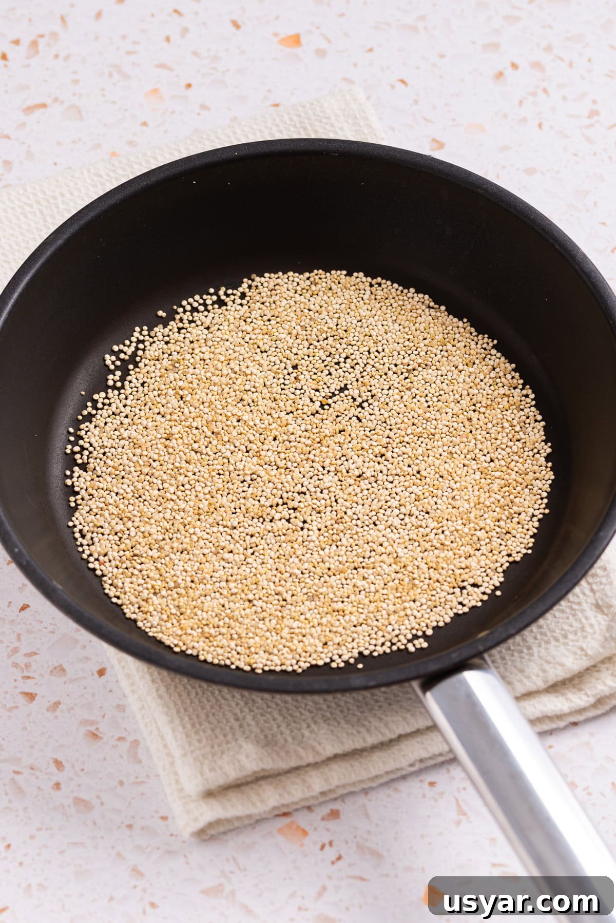 An image of cooking quinoa in a skillet.