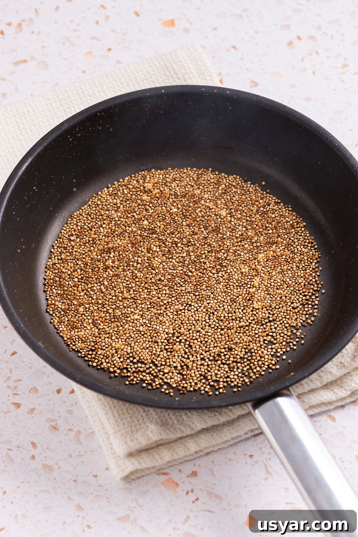 An image of cooking quinoa in a skillet.