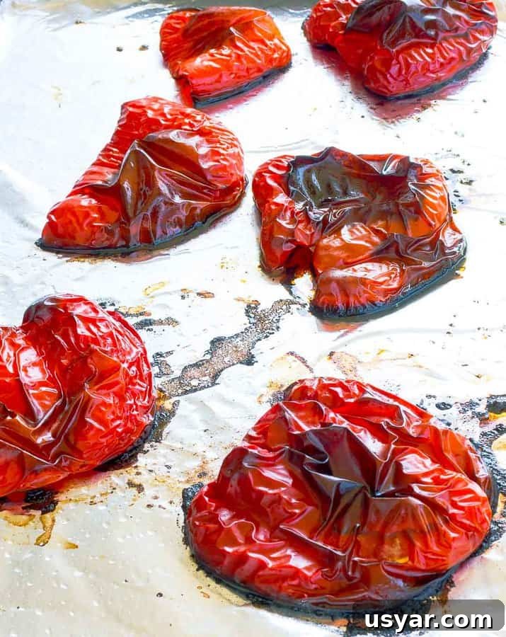 How to Roast Red Peppers at Home 57 Six roasted red pepper halves on a foil-lined cookie sheet