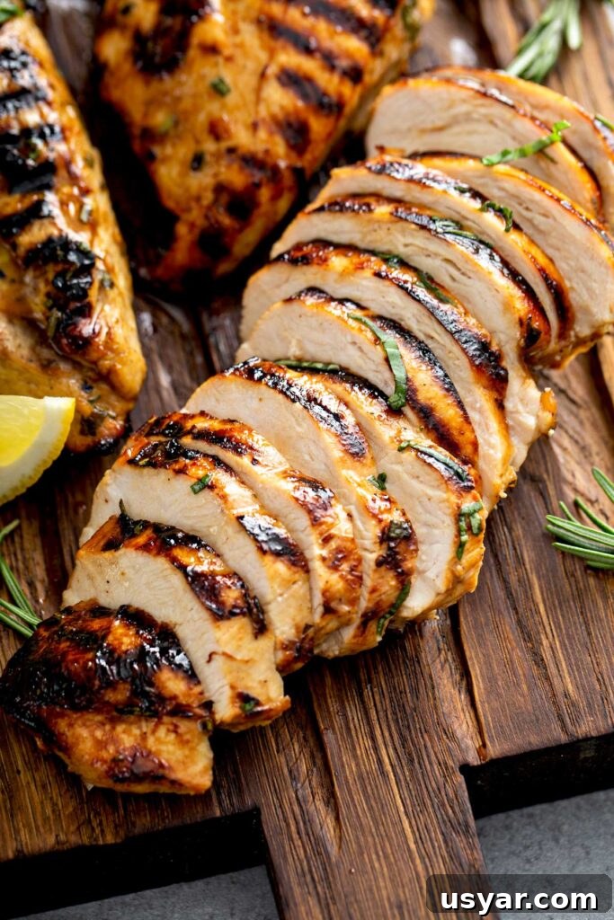 Tangy Balsamic Marinade for Chicken 2 Sliced balsamic marinated chicken breast on a wooden cutting board