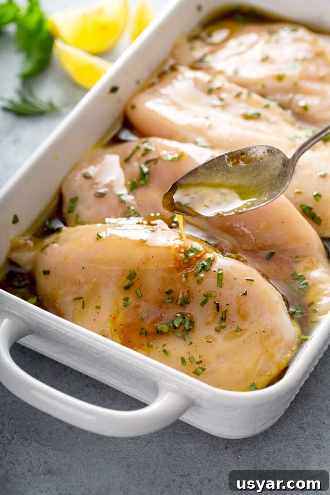Tangy Balsamic Marinade for Chicken 7 Raw chicken breast in a shallow pan marinating on a balsamic and herb marinade