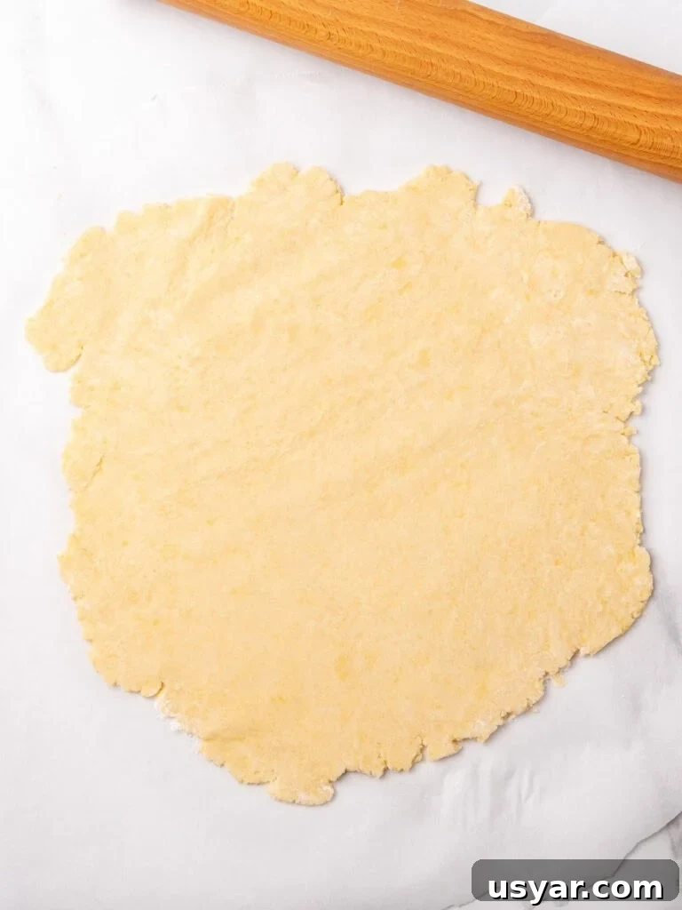 Classic Italian Ricotta Pie Recipe 4 Rolled pie crust on white marble. Rolling pin.
