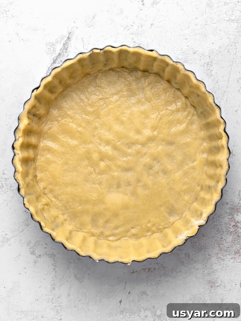 Classic Italian Ricotta Pie Recipe 5 Light gray background with crust-lined pie plate.