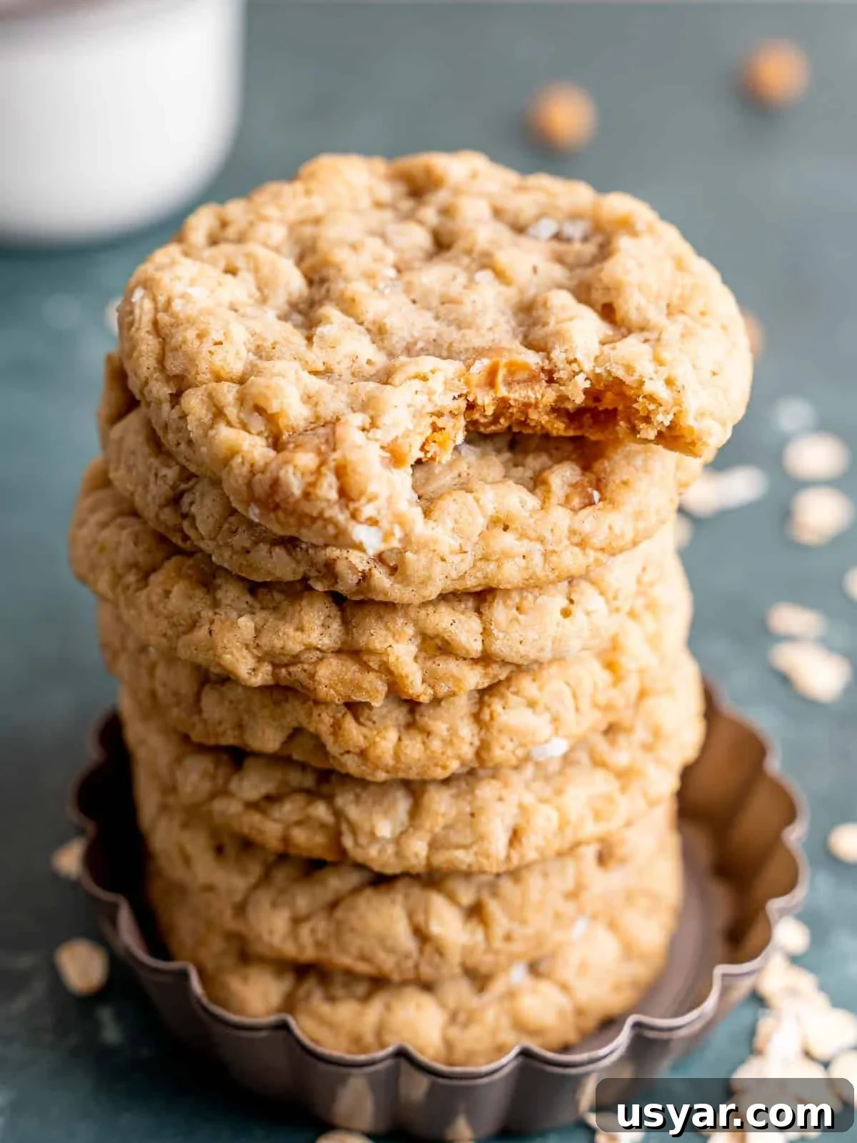 How to Make Chewy Salted Caramel Oatmeal Cookies 10 A stack of caramel oatmeal cookies with a bite taken out of one.
