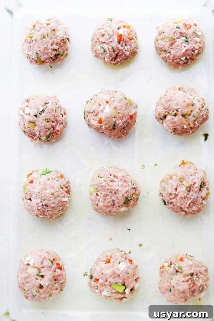 Grilled Turkey Meatball Skewers with Lemon Herb Glaze 9 Shaped turkey meatballs on a white backdrop.