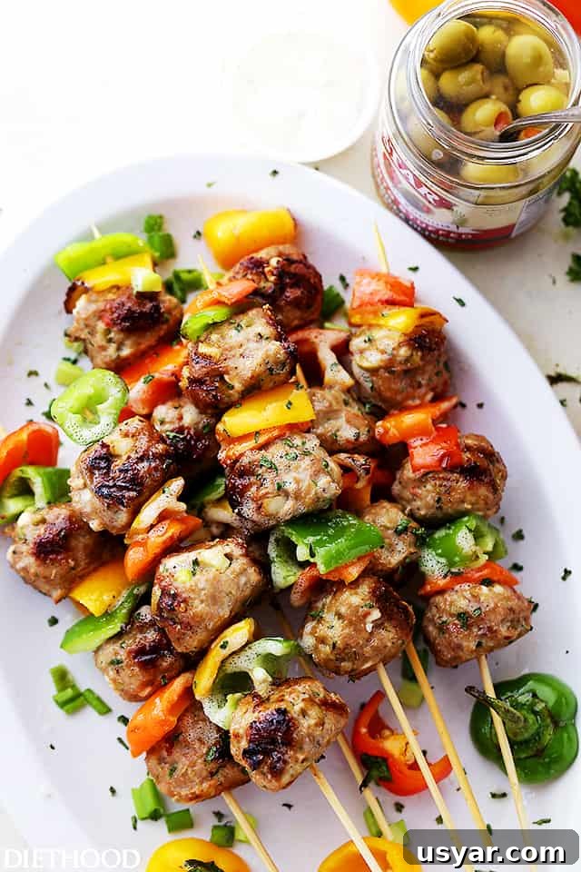 Grilled Turkey Meatball Skewers with Lemon Herb Glaze 4 Meatballs and bell pepper slices on skewers.